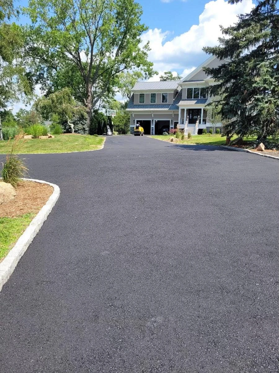 Freshly paved residential asphalt driveway